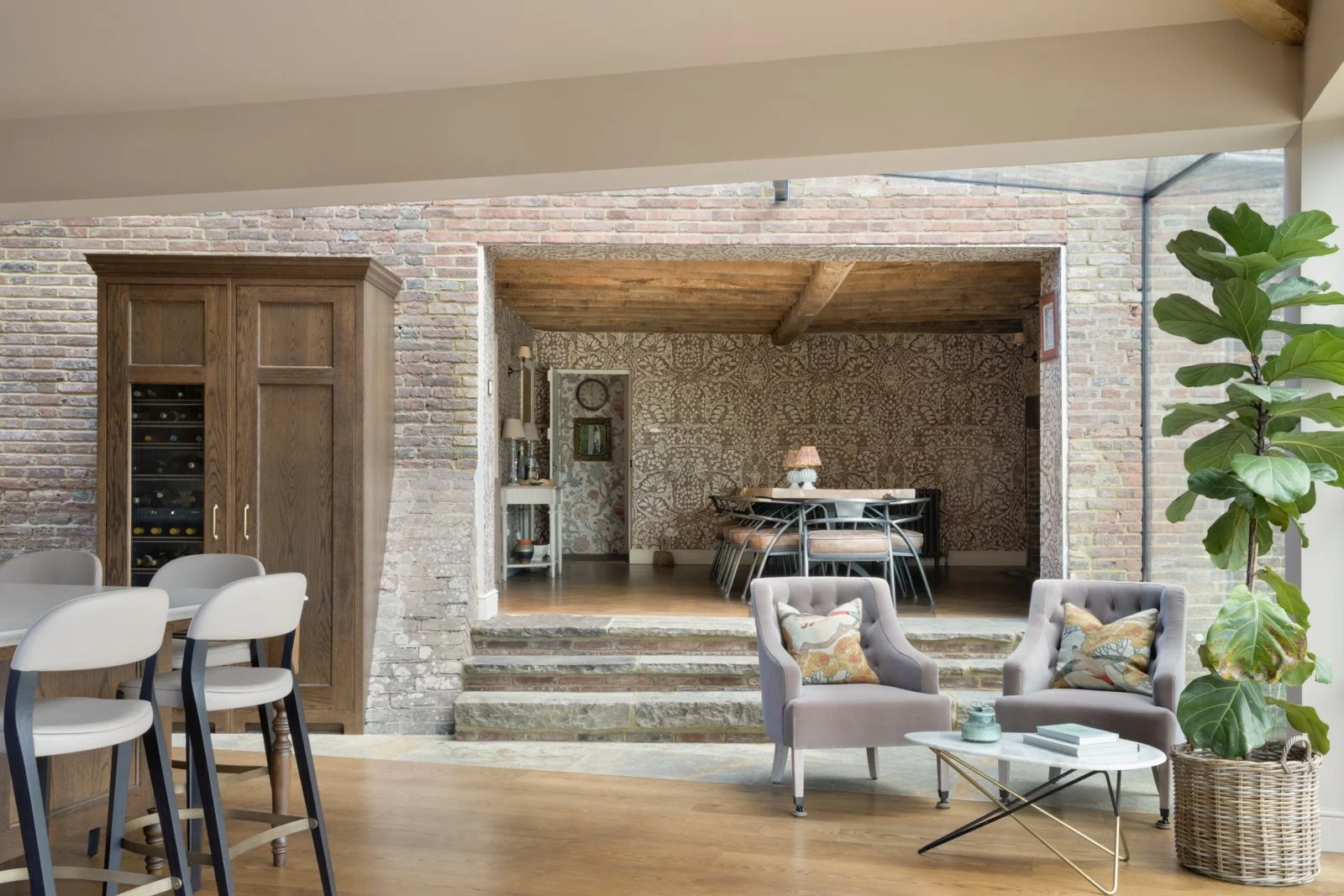 Warm painted kitchen opening into the dining room at Bells Yew Green