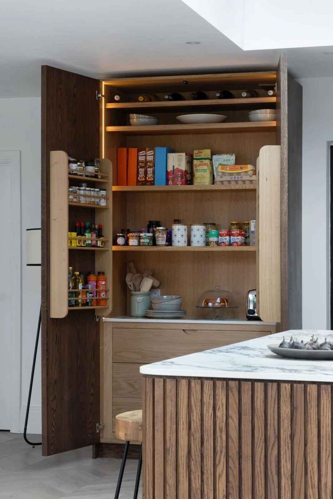 The Hitchin oak larder open, revealing fitted shelves and drawers